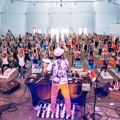 Image: DJ Taz leads a yoga flow with music