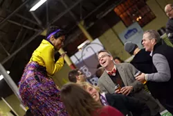 LANDDESIGN - A woman in stilts elevated the mood at Thursday's event.