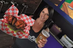 NATRICE BULLARD - Ed's Tavern server Ashleigh Douglas with the Chuck Norris wings