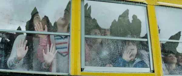 HEARD BUT NOT SEEN: Even the children wonder why Godzilla largely lacks Godzilla. (Photos: Warner Bros.)