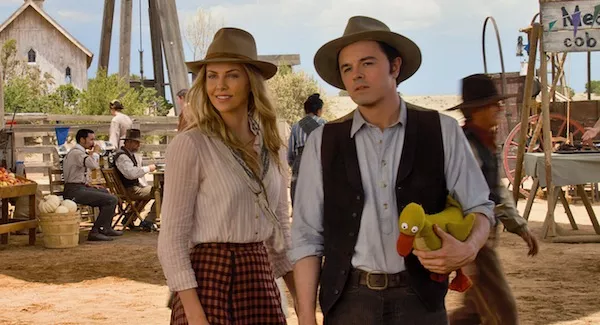 SHOOTING BLANKS: Seth MacFarlane (pictured with Charlize Theron) elected to (mis)cast himself in A Million Ways to Die in the West. (Photo: Universal)