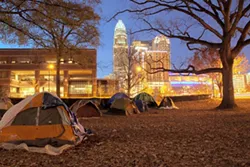 GRANT BALDWIN - The Occupy Charlotte campsite at Old City Hall on East Trade Street at dusk on Nov. 26.