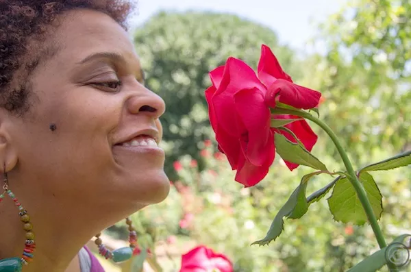 Stacey Rose stops to smell the… well, you know. (Photo by Jonathan Cooper)