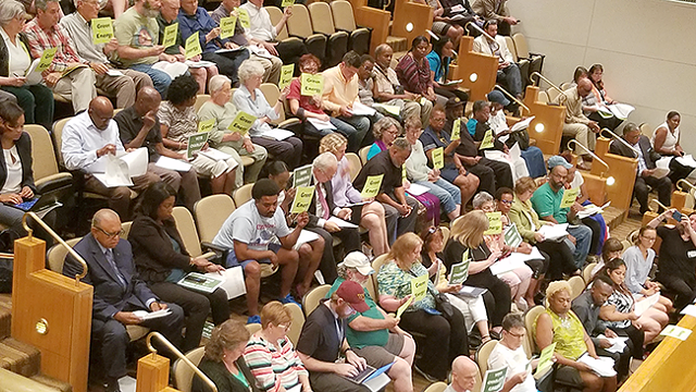 Many residents showed up to the Charlotte City Council meeting on June 25 to show support for a resolution to reduce carbon emissions. The resolution passed unanimously. (Photo by Rhiannon Fionn)