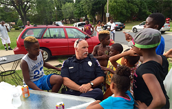 Several children gather around a police officer during a community event. (Courtesy of City of Charlotte)