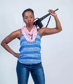 Tracie Frank posing with an automatic rifle prop (Courtesy of Brand New Sheriff Productions)