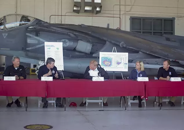 Gov. Roy Cooper (second from left) discusses relief efforts with President Donald Trump (middle) at Marine Corps Air Station in Cherry Point. Photo by Cpl. Micha Pierce.
