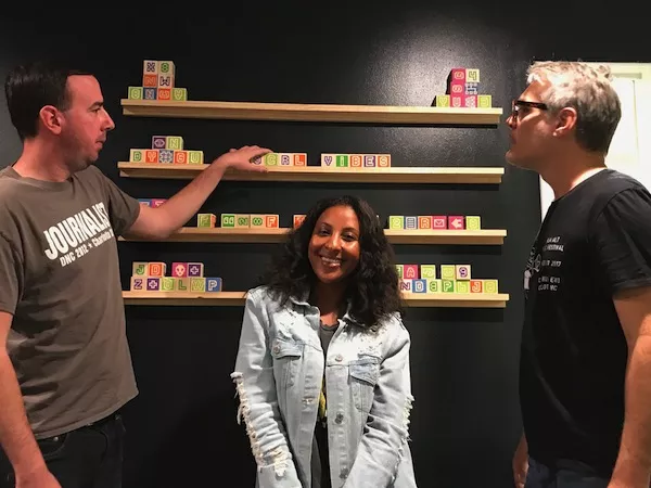 Nikki practices her poses while Ryan (left) and Mark discuss the backdrop.