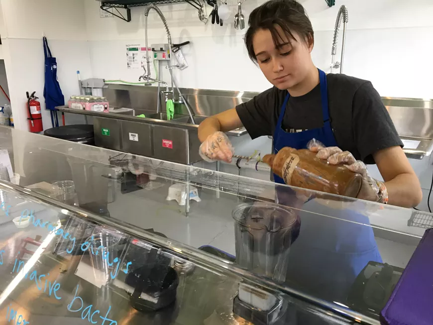 Conner Flowe prepares a smoothie at Juice Box in Noda
