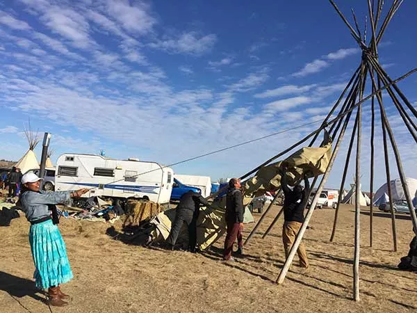 Jasmine S. LaBeau helps re-strike a teepee at the Oceti Sakowin camp on Nov. 15 in preparation for the winter.