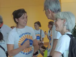 Hanna Mitchell speaks with fellow Repower Our Schools supporters before delivering a petition to the CMS Board of Education.