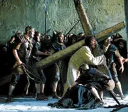 WEIGHT ON HIS SHOULDERS Jesus (Jim Caviezel) - carries the symbol of His own demise in The - Passion of the Christ